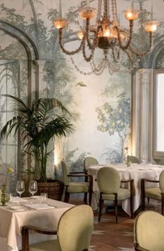 the dining room is decorated with wallpaper and chandeliers