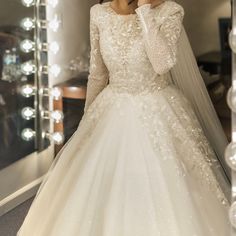 a woman in a white wedding dress is taking a selfie with her cell phone