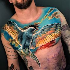 a man with tattoos on his chest has a bird painted on it