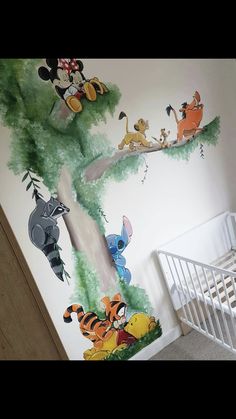 a baby's room with winnie the pooh mural