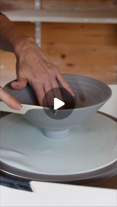 a person using a knife to cut into a bowl