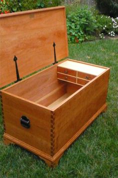 an open wooden box sitting on top of grass