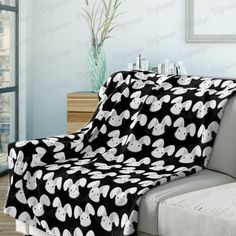 a couch with a black and white blanket on it