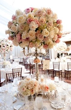 an elegant centerpiece with flowers and candles is displayed in the middle of a banquet hall