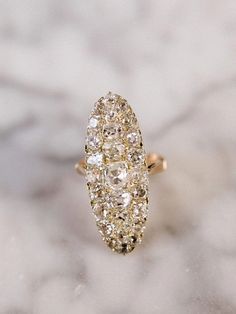 a diamond ring sitting on top of a marble surface