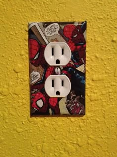 a spiderman themed light switch cover is shown