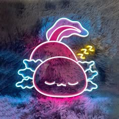 a neon sign that has been placed on a furry surface