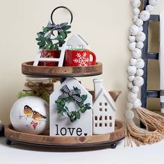 three tiered tray with christmas decorations on it