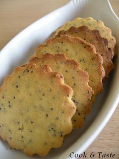 four crackers in a white dish on a wooden table