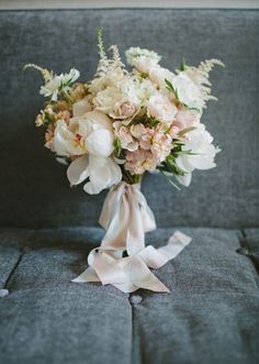 a bouquet of flowers sitting on top of a couch