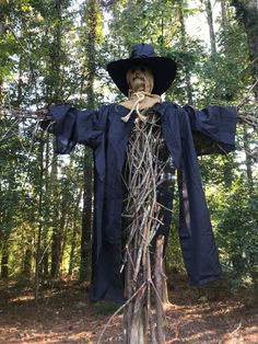 a scarecrow is standing in the woods