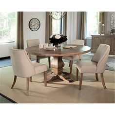 a dining room table with chairs around it and a clock on the wall in the background