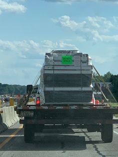 the back end of a large truck on a highway