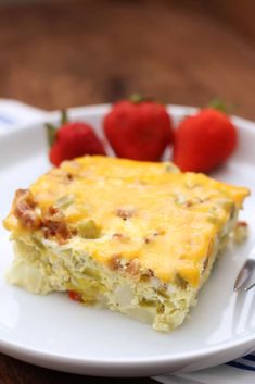 a piece of quiche on a plate with strawberries