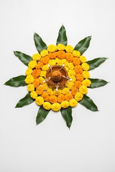 an orange and yellow flower with green leaves around it on a white background stock photos