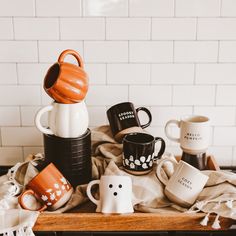 coffee cups and mugs are sitting on a tray