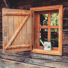 an open window with a watering can in it