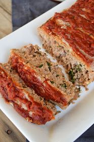 two slices of meatloaf on a white plate