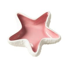 a pink and white star dish on a white background