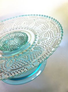 two blue glass plates sitting on top of a table