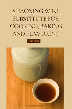 a cup of tea sitting on top of a wooden table next to a jar of wine