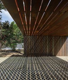 the inside of a building that is made out of wood and metal strips with sunlight shining through it