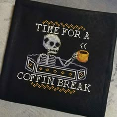 a cross - stitch pattern on a black cloth with the words time for a coffee break