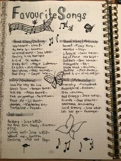 an open notebook with writing on it and music notes written in the bottom right corner