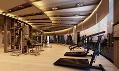 an empty gym with treadmills and exercise machines in the foreground, overlooking cityscape