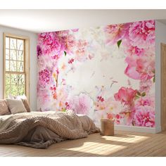 a bedroom with pink flowers painted on the wall and bed in the foreground, next to a window