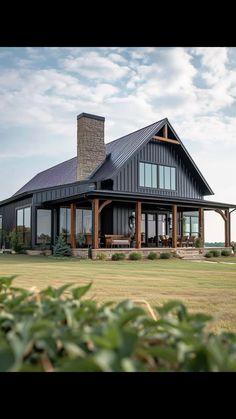 a large house sitting on top of a lush green field