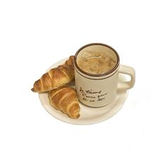 two croissants on a plate next to a cup of tea