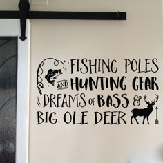 fishing poles and hunting gear wall decal on the side of a door in a room