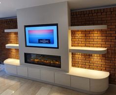 a flat screen tv mounted on the side of a wall next to a fireplace in a living room