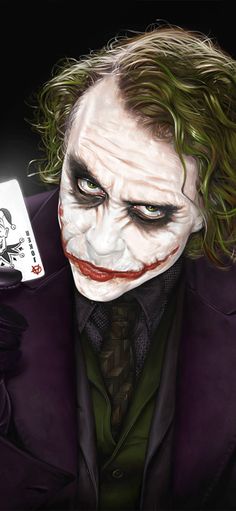 the joker holding a playing card in his hand