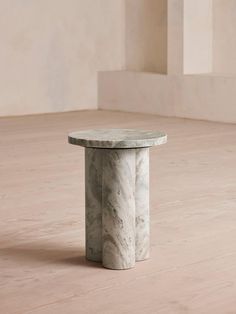 a marble table sitting on top of a hard wood floor