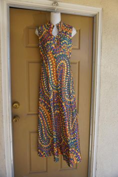 Vintage 1970s maxi dress.  No tags fits like a Large. In good vintage condition. no stains, holes, or tears. Please see measurements.Measurements taken across front lying flat 19" across front armpit to armpit14" across front of empire waist17" across natural waist55" length Retro Print Maxi Dress For Summer, 70s Inspired Fitted Maxi Dress, 1970s Fitted Multicolor Maxi Dress, 1970s Style Fitted Multicolor Maxi Dress, Vintage Multicolor Sleeveless Maxi Dress, 1970s Fitted Floor-length Maxi Dress, 1970s Style Multicolor Maxi Dress, Multicolor Sleeveless Vintage Maxi Dress, 1970s Style Fitted Floor-length Maxi Dress