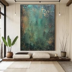 an abstract painting hangs on the wall above a couch in a room with large windows