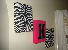 the wall is decorated with zebra prints and pink accents