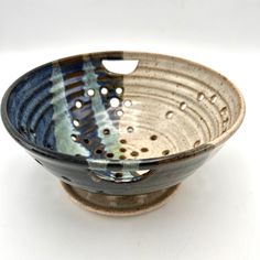 a blue and white bowl with holes in it