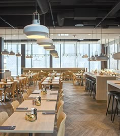 an empty restaurant with wooden tables and chairs