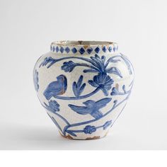 a blue and white vase with birds on it