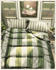 a bed with green and white striped comforter next to a painting on the wall