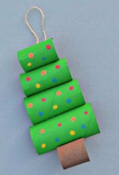 four rolls of toilet paper are stacked on top of each other in the shape of a christmas tree