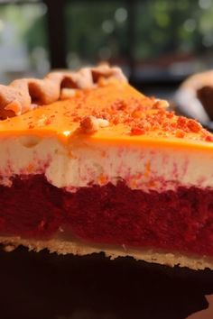 a slice of red velvet pie with white and yellow frosting on it's crust