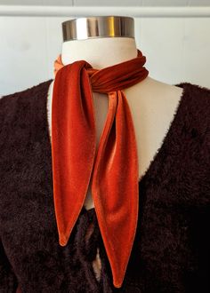 All accessories are final sale Add a lil rock and roll to your 'fit with this dreamy velvet scarf tie. Made from plush stretch velvet in a burnt orange colorway. Wear it tied around your neck, as a headband, as a hat band, tied around a belt loop, whatever ya like! Features: Scarf tie Stretch plush velvet Burnt orange colorway Handmade in LA Brand & Fabric Content: Brand: I'm With the BandMaterials: stretch velvet Made in: Los Angeles, CA Approx. measurements: Approx. 33" long and 2.5" wide when Velvet Scarf, Black Salt, Scarf Tie, March Hare, Orange Scarf, Ankle Length Skirt, Orange Velvet, Tie Scarf, I'm With The Band