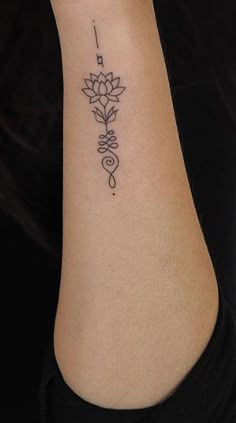 a woman's arm with a flower tattoo on the left side of her body