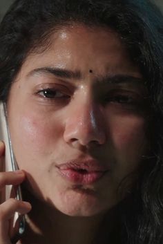 a close up of a person talking on a cell phone