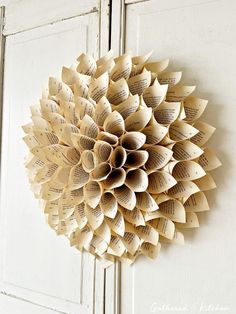 an open book page wreath hanging on a door