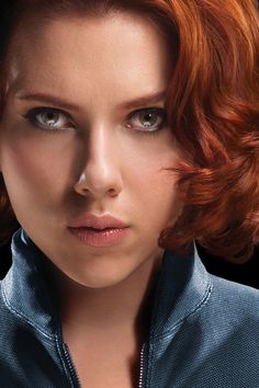 a woman with red hair and blue shirt